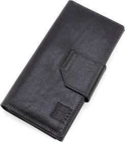 Крупный кожаный кошелек черного цвета с хлястиком на магните Grande Pelle 67810